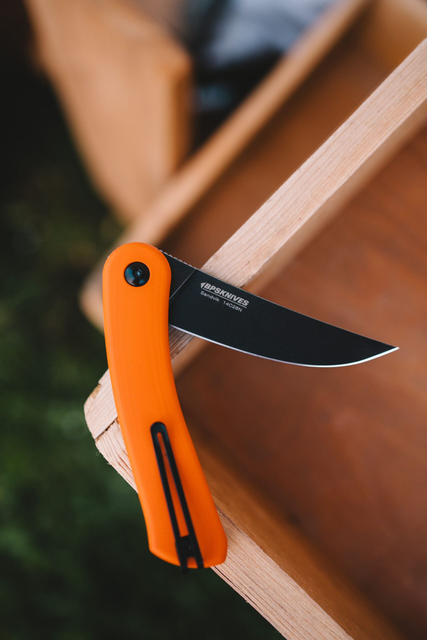 8 Hand Holding Orange Folding Knife